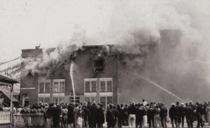 A group of people watch firemen put out a fire at the Avon Hotel rooms on May 8, 1938. Photo courtesy of San Juan County Historical Society