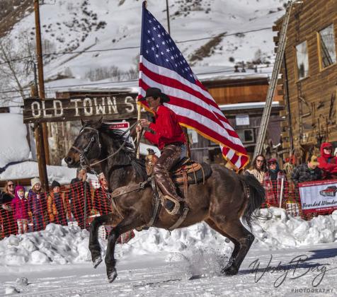 The flag and rider at the start of the Skijoring weekend. Photo Credit Wesley Berg
