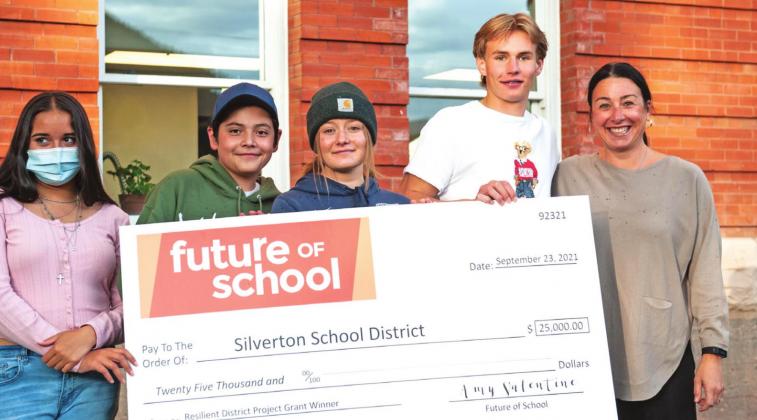 Silverton High School students accepted the award alongside school leadership. Left to right Karely Ortega, Alejandro Torres, Kharis Weller, Paton Edwards, and Amy Valentine (from Future of Schools) hold the giant check. Photo Credit David Emory.