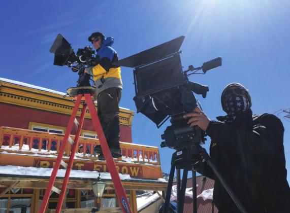 A production crew of 75 folks took over town during filming. Here 2 cameramen work their magic outside of The Bent Elbow. Photo Credit Rebecca Bertot